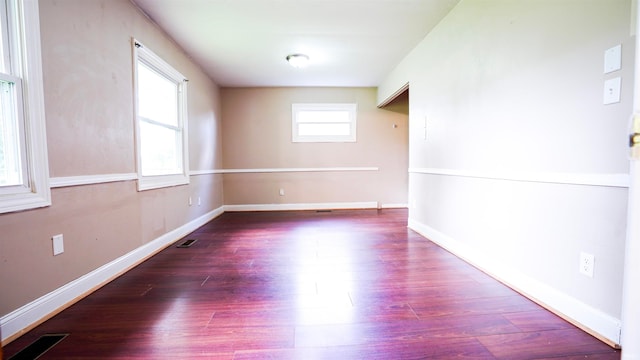 empty room featuring dark hardwood / wood-style flooring