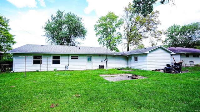 back of house with a lawn