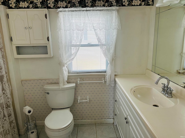 bathroom with vanity, toilet, and tile patterned floors