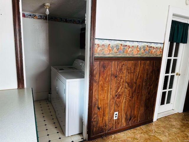 washroom featuring a textured ceiling and separate washer and dryer