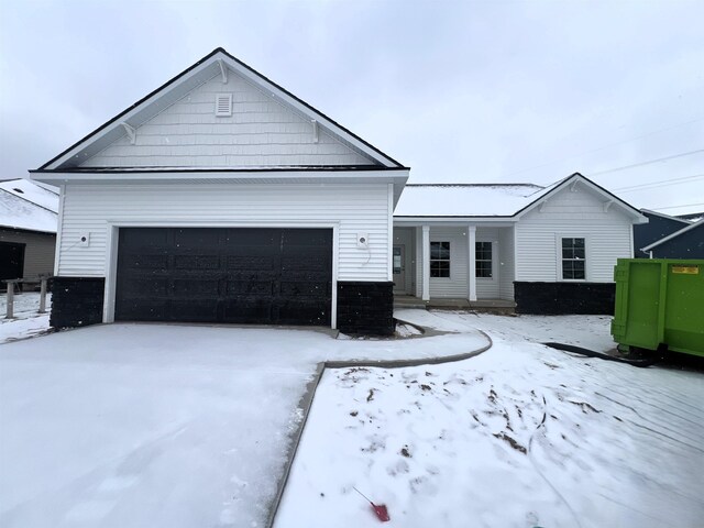 view of front of house featuring a garage and a front lawn