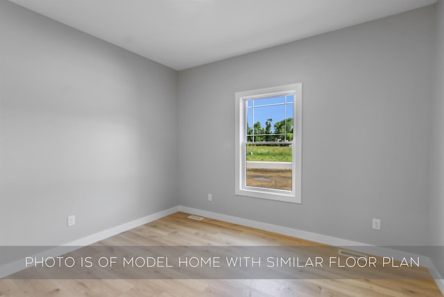 empty room featuring baseboards and wood finished floors