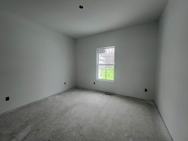 unfurnished room with visible vents