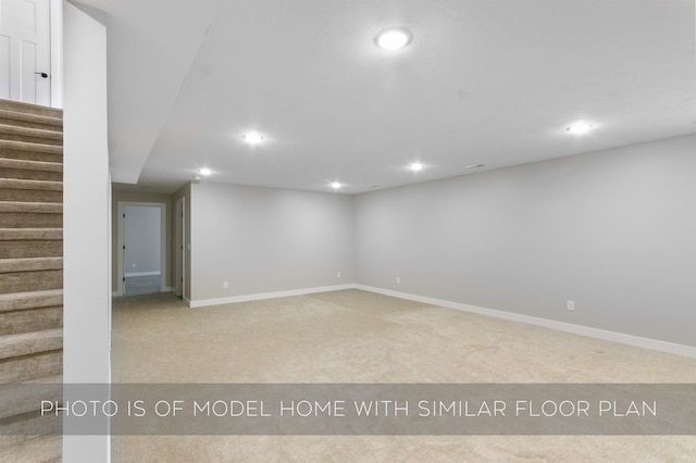 finished basement with carpet, stairway, baseboards, and recessed lighting