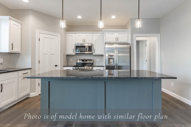 kitchen featuring stainless steel appliances, dark wood-style flooring, a kitchen island, and white cabinetry