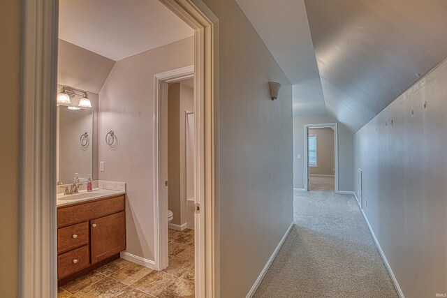 walk in closet featuring light colored carpet