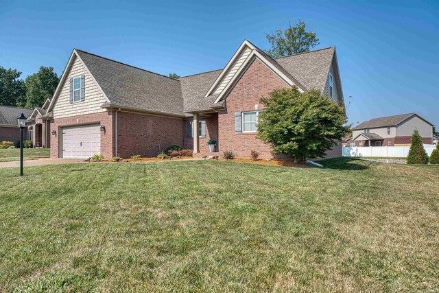 view of front of property featuring a garage and a front yard