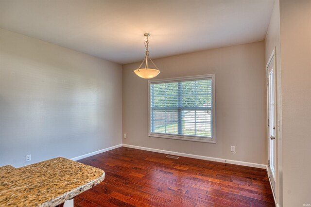 empty room featuring dark hardwood / wood-style flooring