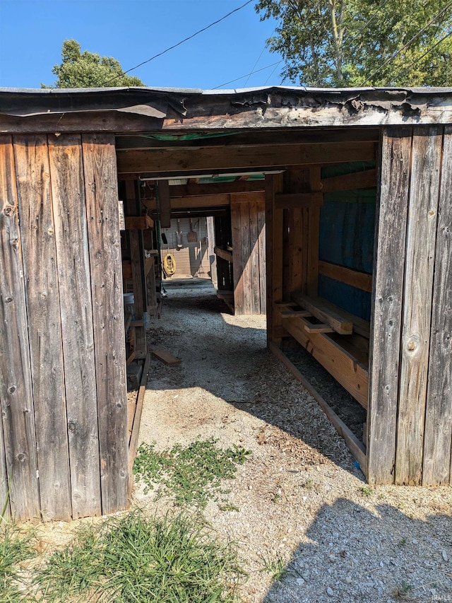 view of outbuilding featuring a carport, an exterior structure, and an outdoor structure