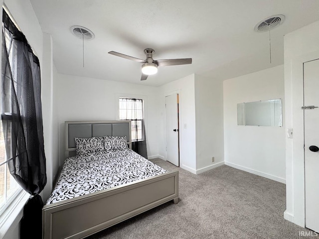 carpeted bedroom with baseboards, visible vents, and attic access