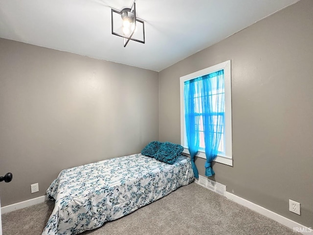 bedroom with carpet and baseboards