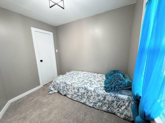 bedroom with carpet and baseboards