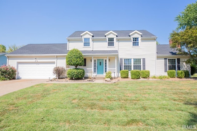 view of front of house featuring a garage, covered porch, and a front yard