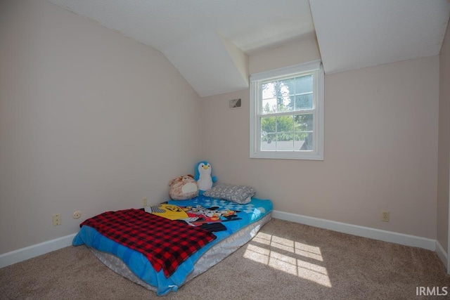 bedroom with carpet floors and vaulted ceiling