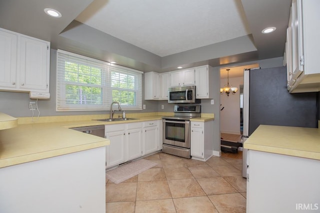 kitchen featuring a notable chandelier, white cabinetry, light tile patterned floors, sink, and appliances with stainless steel finishes