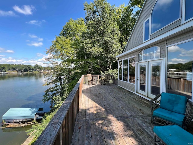 wooden terrace featuring a water view