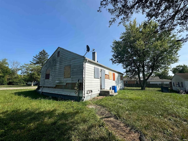 view of property exterior featuring a lawn