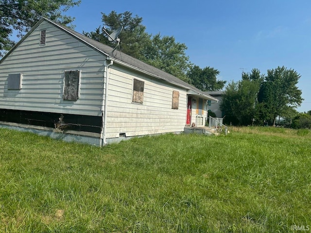 view of side of home featuring a yard