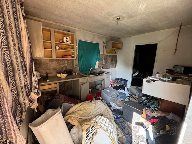 miscellaneous room with a textured ceiling