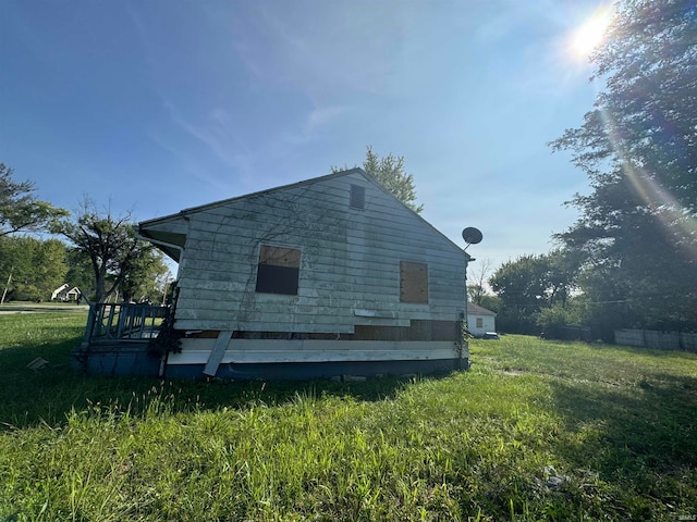 view of property exterior featuring a lawn and a deck