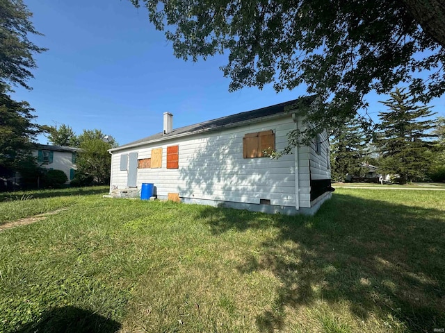 back of house with a lawn