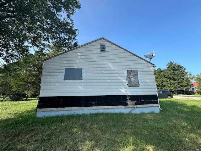 view of side of home with a lawn