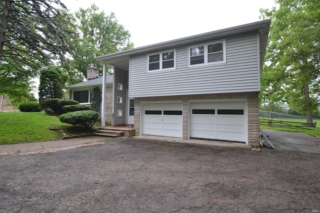 view of front facade with a garage and a front lawn