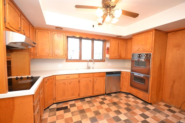 kitchen with black appliances, ceiling fan, a raised ceiling, and sink