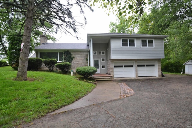 split level home with a garage and a front yard