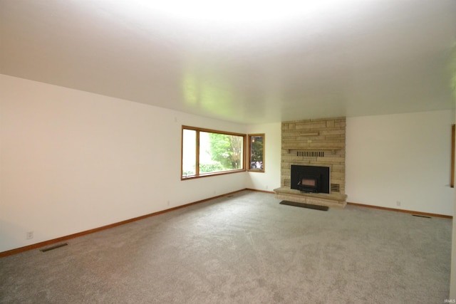 unfurnished living room with a fireplace and light colored carpet