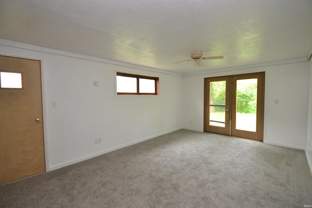 carpeted spare room with french doors and ceiling fan