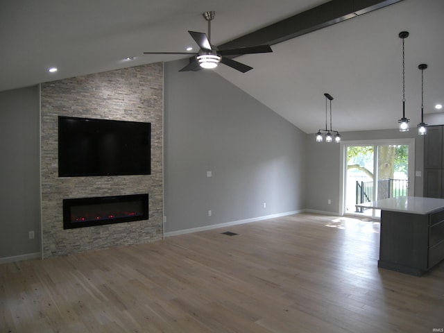 unfurnished living room with light wood finished floors, a fireplace, visible vents, and baseboards