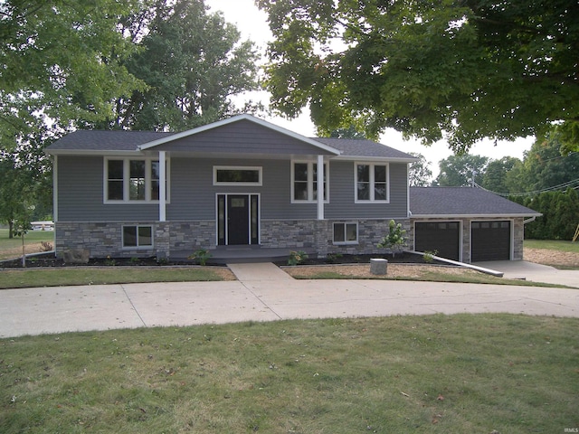 split foyer home featuring a front yard and a garage