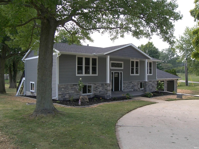 raised ranch with a front lawn