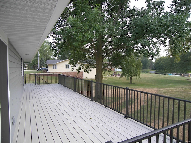 wooden terrace with a lawn