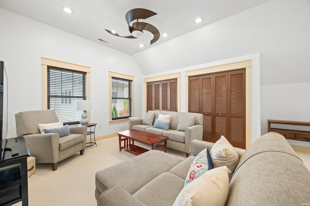 living room with light colored carpet, vaulted ceiling, and ceiling fan