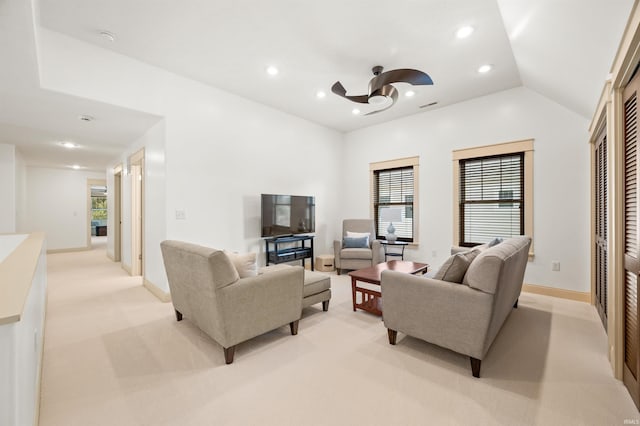 carpeted living room featuring a wealth of natural light, vaulted ceiling, and ceiling fan