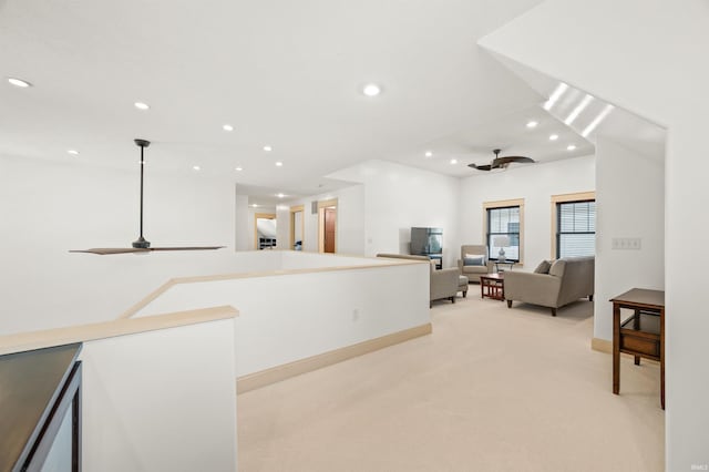 interior space featuring ceiling fan and light carpet