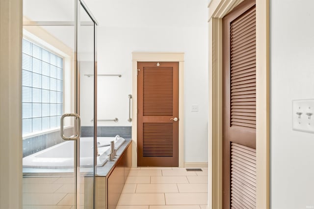 bathroom featuring a healthy amount of sunlight, tile patterned floors, and shower with separate bathtub