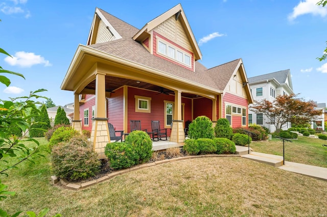 craftsman-style home featuring a porch and a front yard