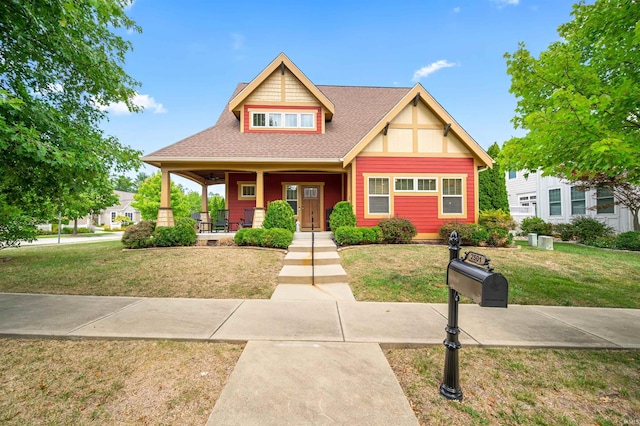 view of front of home with a front yard and covered porch