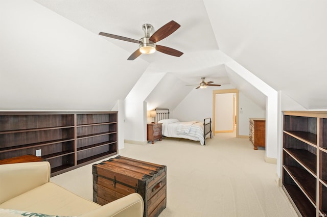 bedroom featuring lofted ceiling, light colored carpet, and ceiling fan