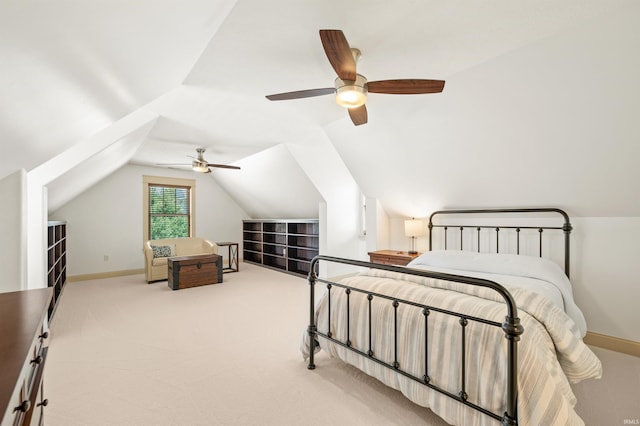 carpeted bedroom with ceiling fan and vaulted ceiling