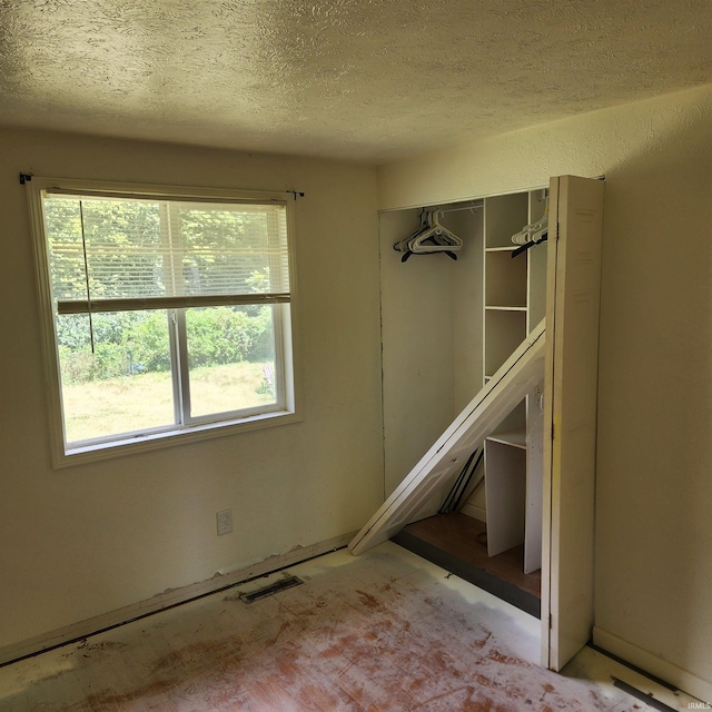 empty room with a textured ceiling