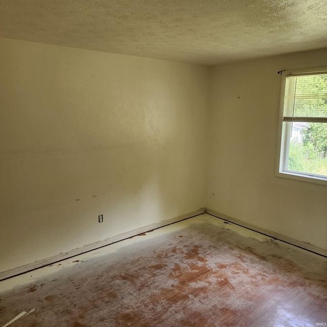 empty room with a textured ceiling