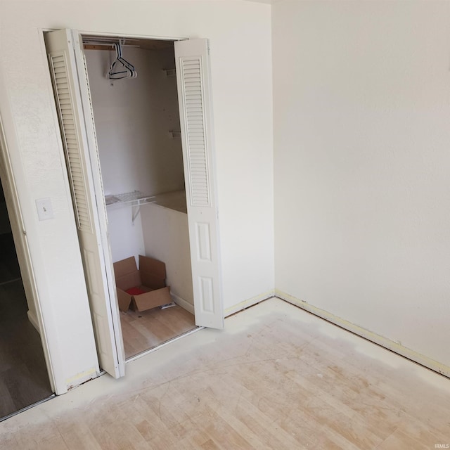 unfurnished bedroom featuring a closet and light hardwood / wood-style floors