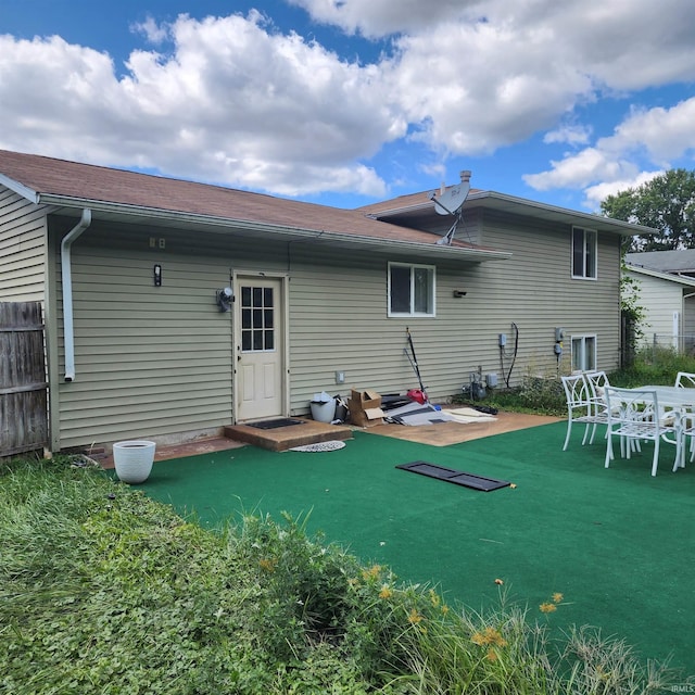 back of property featuring a yard and a patio