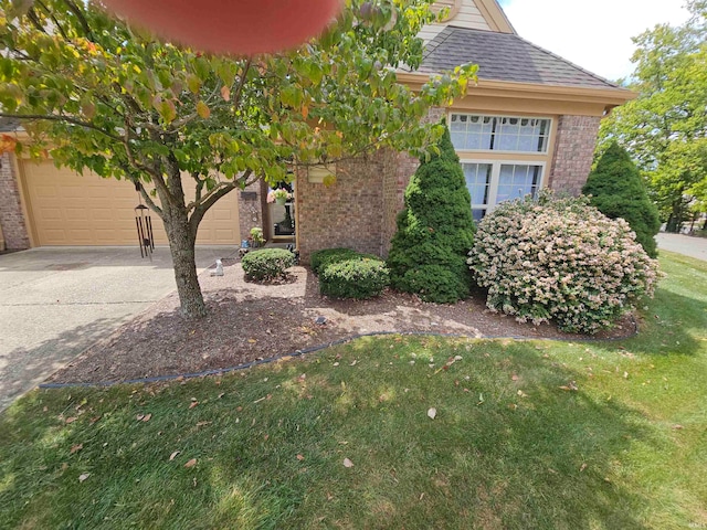 view of front facade with a front yard and a garage