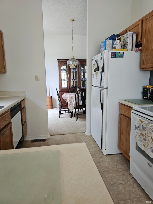 kitchen featuring dishwasher, decorative light fixtures, a notable chandelier, white electric stove, and a textured ceiling