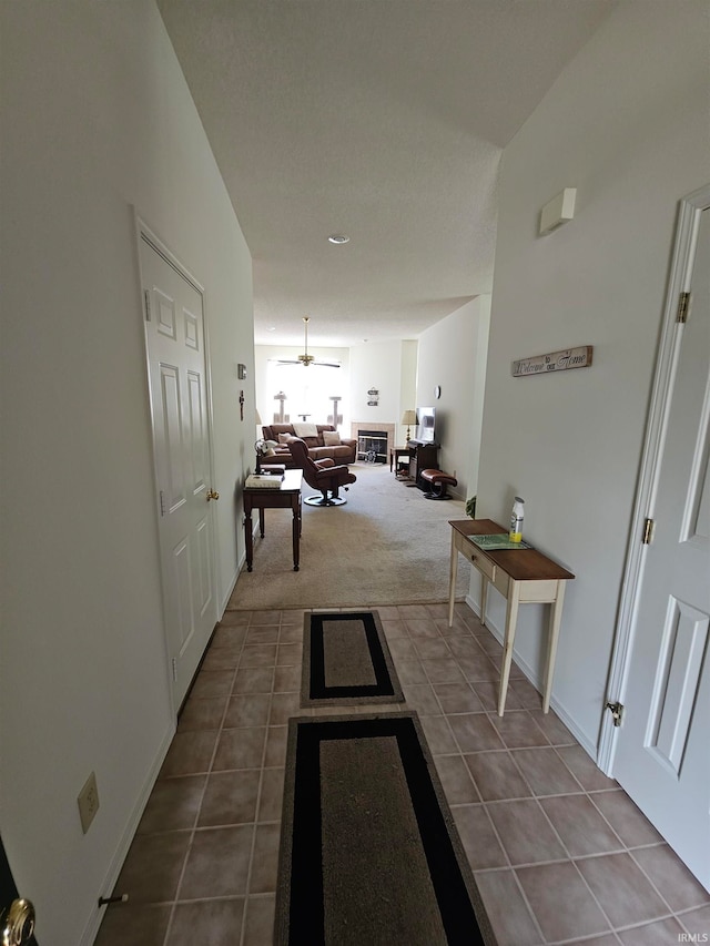 hall with an inviting chandelier and tile patterned floors